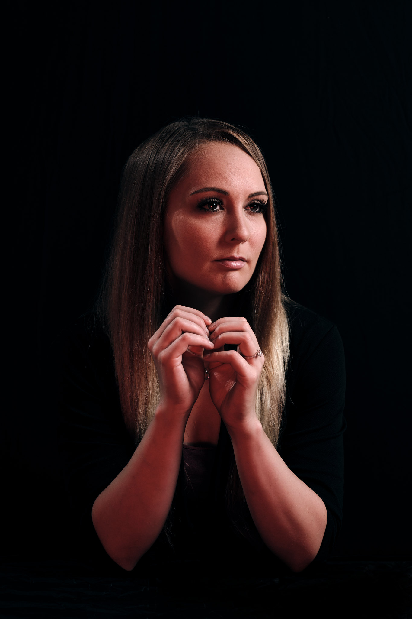 Portrait, hands gathered at the chin